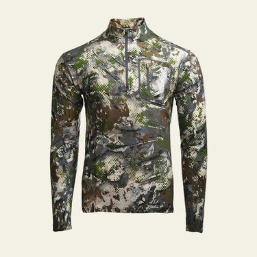 SKRE merino wool hunting baselayer top worn in alpine backcountry conditions